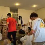 Voluntários da empresa de investimentos Faz Capital, durante uma triagem de doações em Porto Alegre - RS
