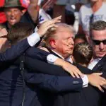 Republican presidential candidate and former U.S. President Donald Trump is assisted by the Secret Service after gunfire rang out during a campaign rally at the Butler Farm Show in Butler, Pennsylvania, U.S., July 13, 2024. REUTERS/Brendan McDermid