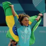 Rebeca Andrade comemora com a bandeira do Brasil, depois de ganhar medalha de ouro na final do Solo Feminino de Ginástica Artística - 5/8/2024 | Mike Blake/Reuters