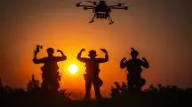 Militares ucranianos vibram em campo de batalha, no sudoeste da Rússia. Na imagem, um drone aparece acima dos soldados