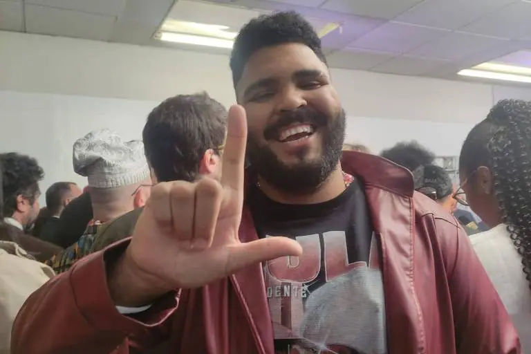 Foto do comediante Paulo Vieira fazendo o L