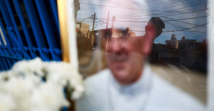 Uma pessoa observa uma imagem do papa Francisco, colocada do lado de fora da Capela da Virgem de Caacupe, depois da morte do pontífice, em Buenos Aires - 24/4/2025 | Matias Baglietto/Reuters