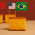Com bandeirinhas fincadas nos pedaços de bolo, a vereadora catarinense comparou a carga tributária de cinco países — Noruega, China, Estados Unidos, Chile e Brasil | Foto: Divulgação/Oeste | Imagem gerada com o auxílio de inteligência artificial