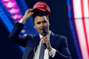 Charlie Kirk, fundador da Turning Point USA, coloca um boné MAGA durante a conferência AmericaFest 2024, patrocinada pelo grupo de direita Turning Point, em Phoenix, Arizona, EUA, em 19 de dezembro de 2024. REUTERS/Cheney Orr/Foto de arquivo