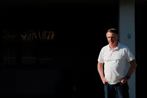 O ex-presidente do Brasil, Jair Bolsonaro, observa de sua casa enquanto o governador de São Paulo, Tarcisio de Freitas (não aparece na foto), deixa Brasília após uma visita (29/9/2025) | Foto: Reuters/Diego Herculano/Foto de Arquivo