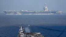 Em segundo plano, o USS Gerald R. Ford, o maior porta-aviões do mundo, que está em missão na América Latina | Foto: Reprodução/Twitter/X