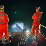 Bombeiros observam casco de embarcação que se chocou com píer na noite deste sábado, no interior de Minas Gerais | Foto: Divulgação/Corpo de Bombeiros