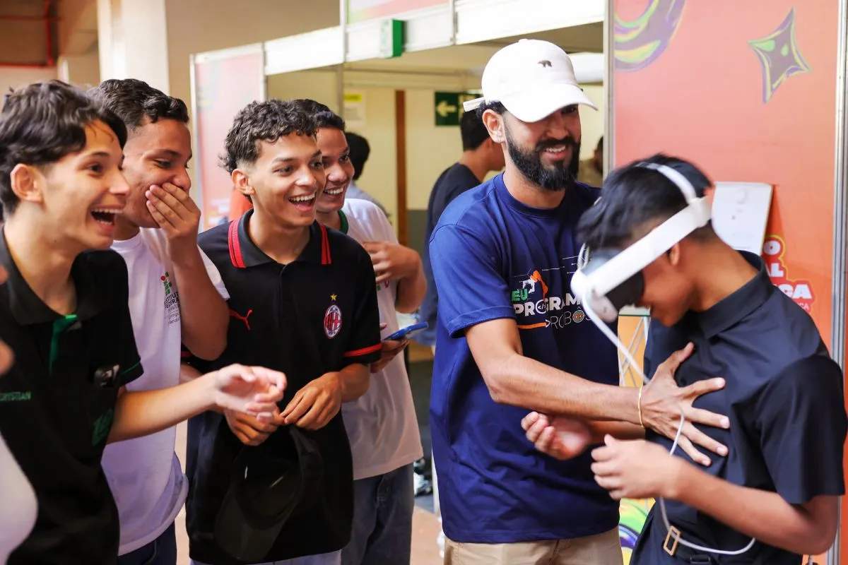 Estudantes participam de atividade escolar com óculos de realidade virtual em ambiente educacional.