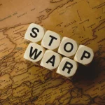 Palavras Stop War formadas com blocos sobre mapa da Europa destacando Rússia e países vizinhos