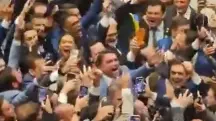 No centro da imagem, de terno claro, Flávio comemora resultado no Senado em meio a dezenas de aliados | Foto: Reprodução/X/@FlavioBolsonaro