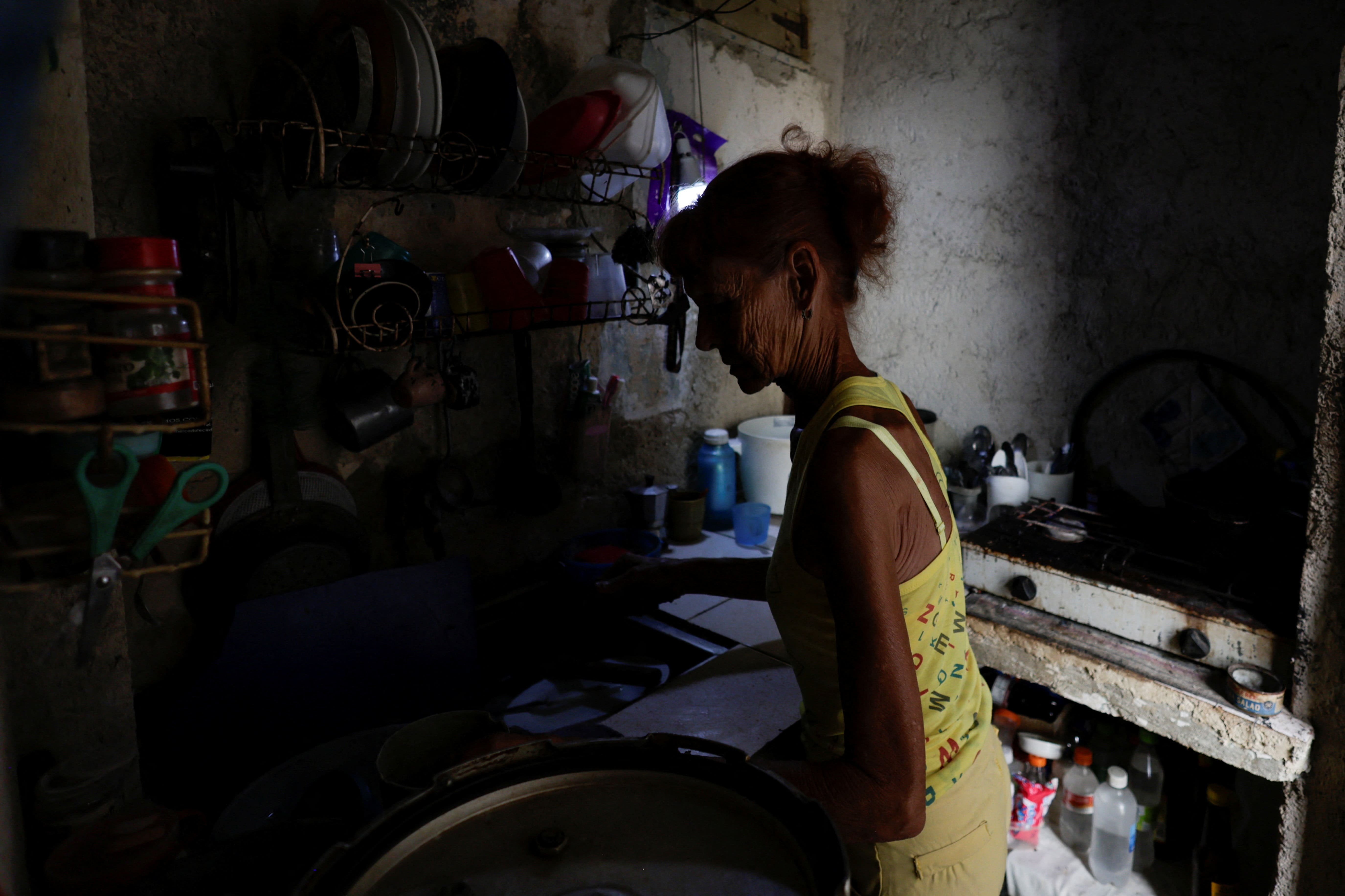 Ana Maria Vazquez prepara café em sua casa, enquanto a rede elétrica de Cuba sofreu um colapso parcial na madrugada de 14 de maio deste ano | Foto: Norlys Perez/Reuters