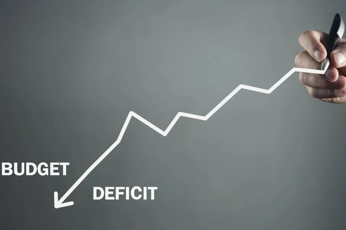 Gráfico ascendente com a palavra deficit relacionada ao orçamento público e controle das contas governamentais