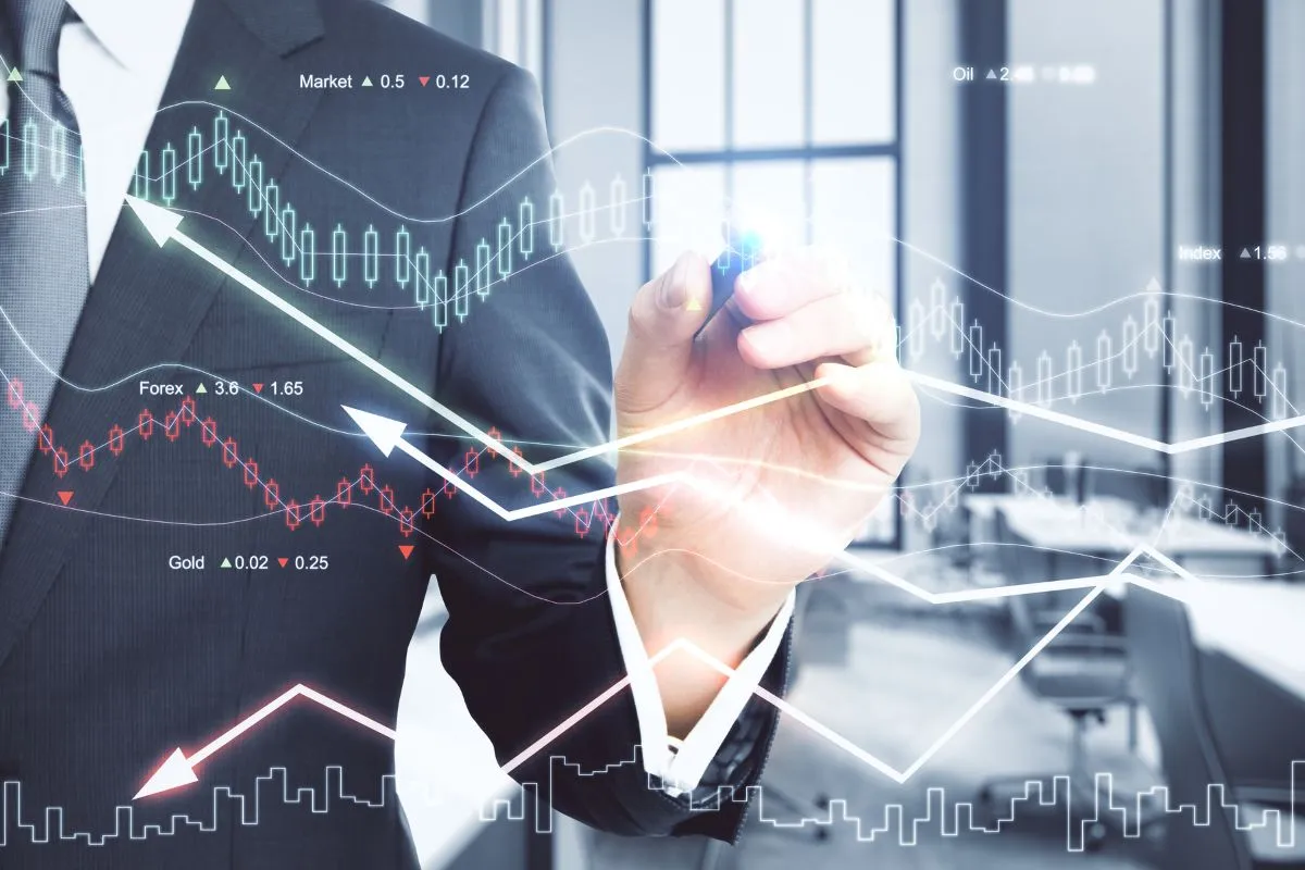 Executivo analisando gráficos financeiros digitais com indicadores de mercado e tendência de investimentos